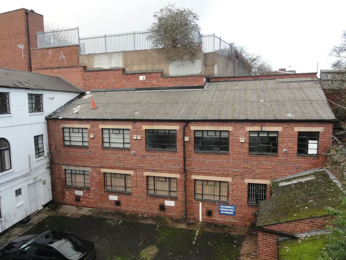Rear brick elevation of a commercial building before subdivision
