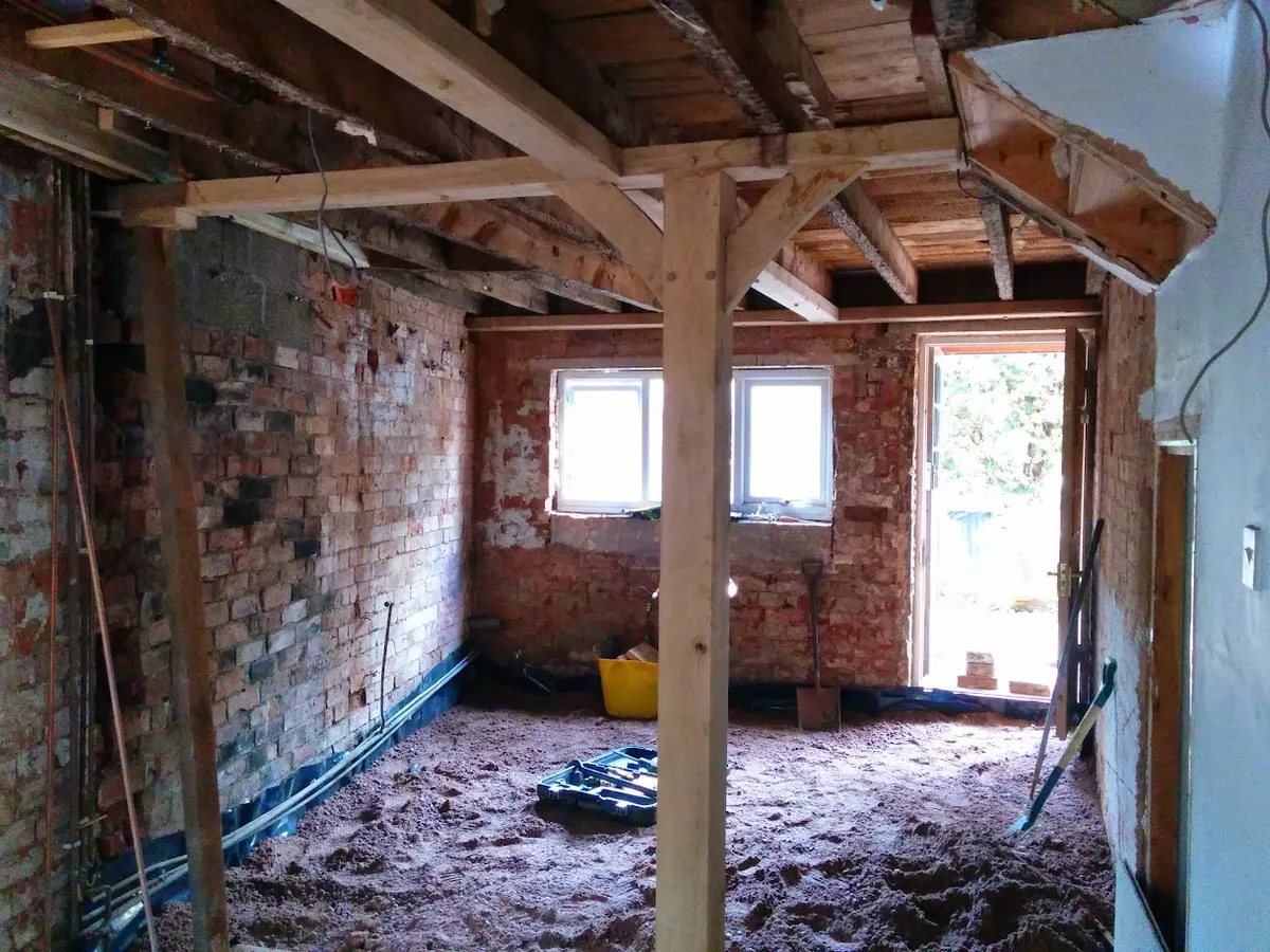 Cottage interior mid-works with new timber frame, services and exposed brickwork